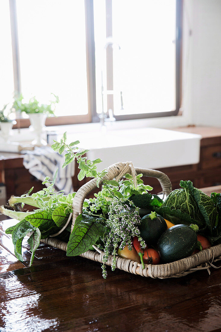 Basket of vegetables on wooden table