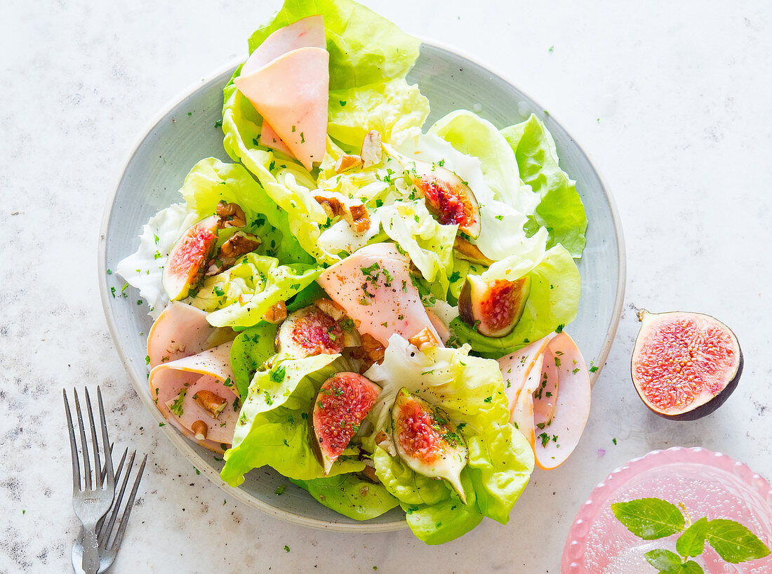 A mixed leaf salad with figs and turkey breast