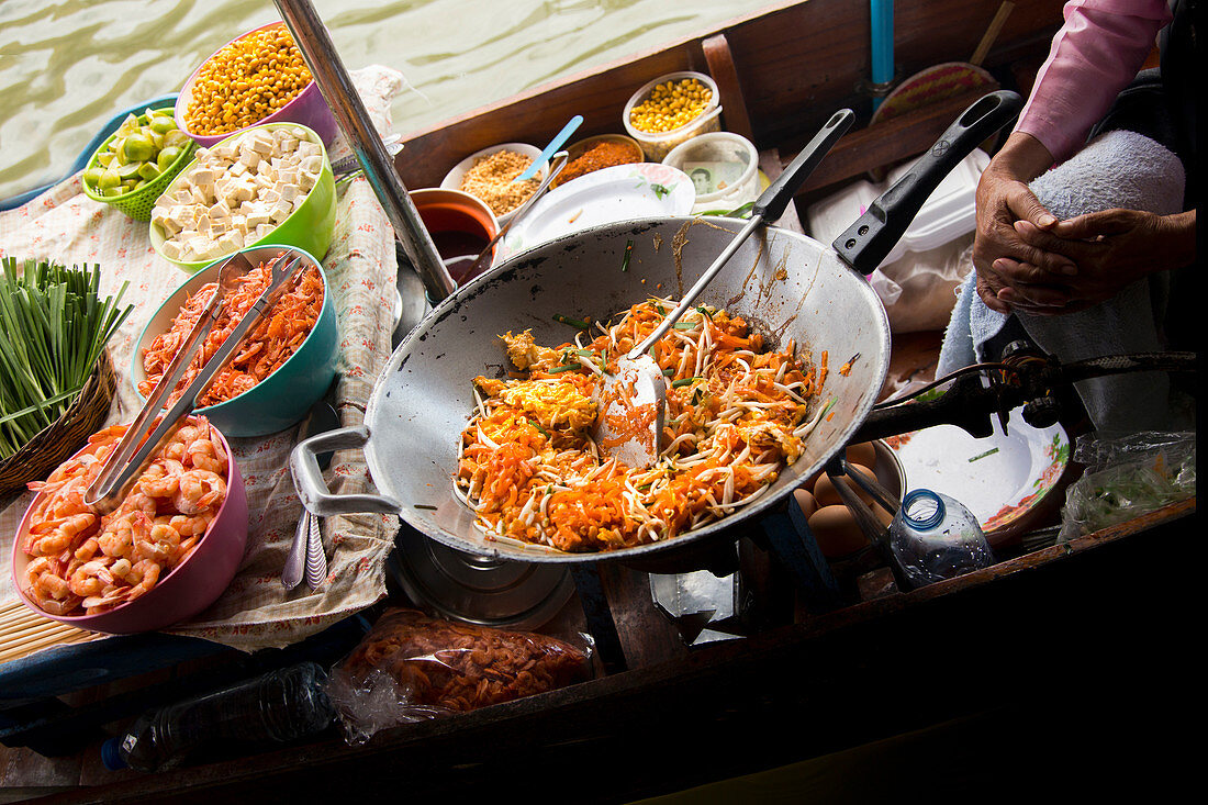 A Pad Thai street food stand in a boat in Tha Kha Floating Market, Samut Songkhram province, Thailand