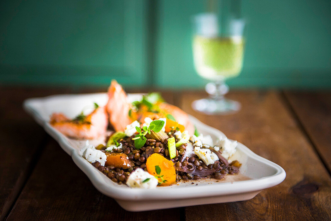 Wine cookte french puy lentils with salmon and feta cheese