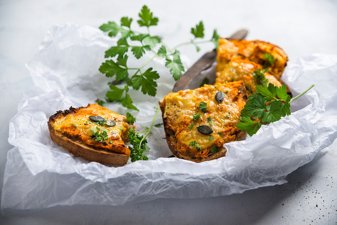 Bread topped with cheese substitute with vegan pumpkin and chickpea spread