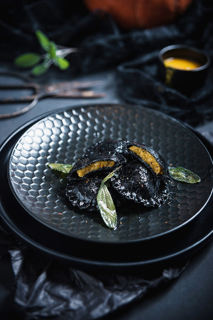 Black vegan ravioli (dyed with active charcoal) in sage butter filled with pumpkin purée