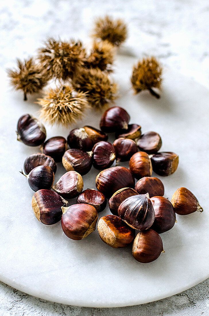 Edible chestnuts cleaned and unpeeled on a marble board