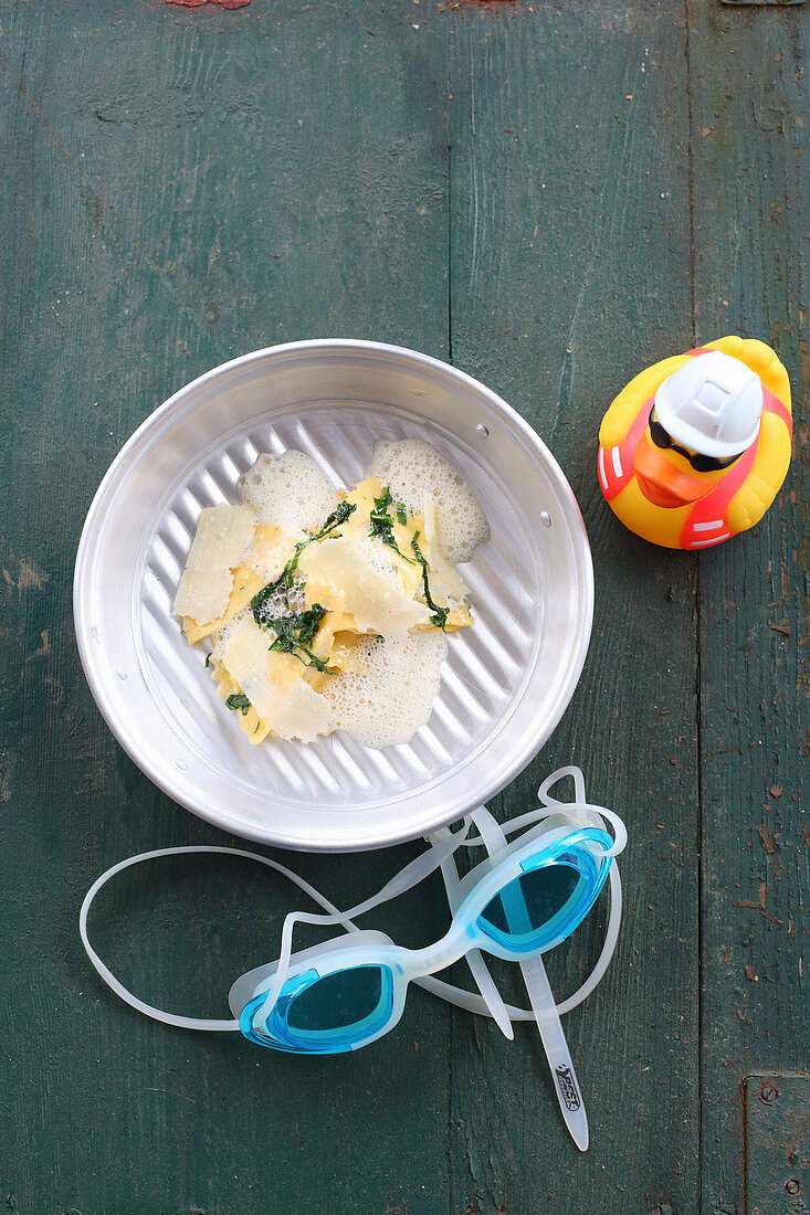 Ravioli with a bread dumpling filling on Parmesan foam