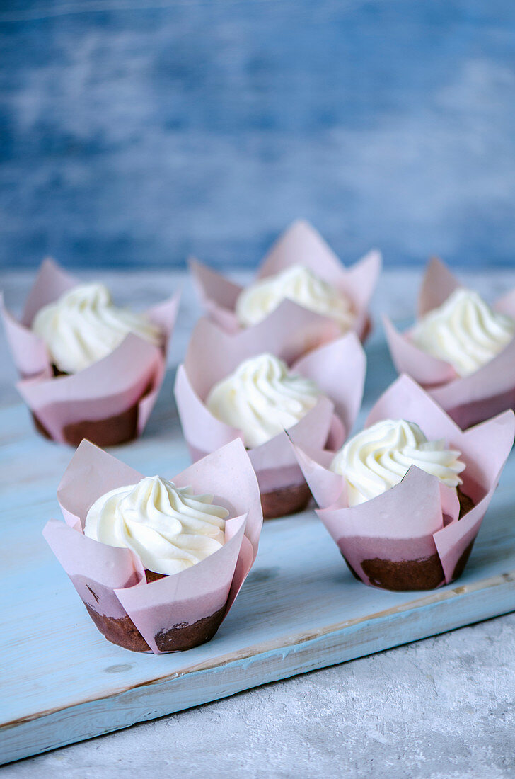 Chocolate cupcakes in pink tulip forms with butter cream