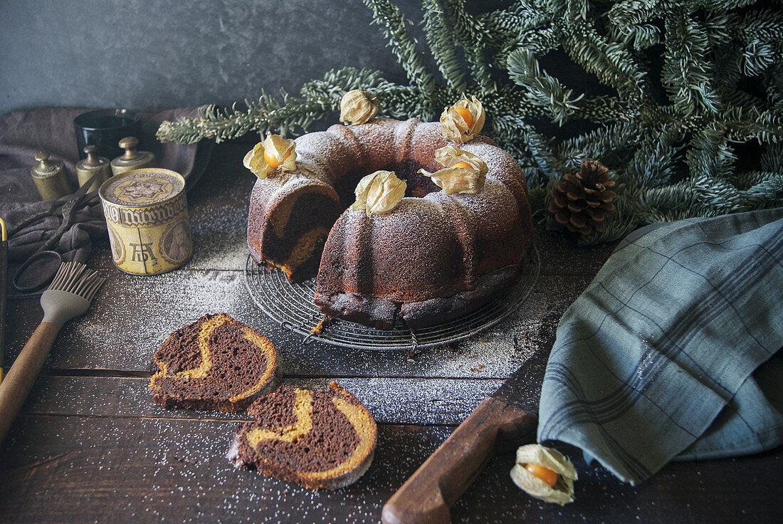 A chocolate and pumpkin wreath cake garnished with physalis