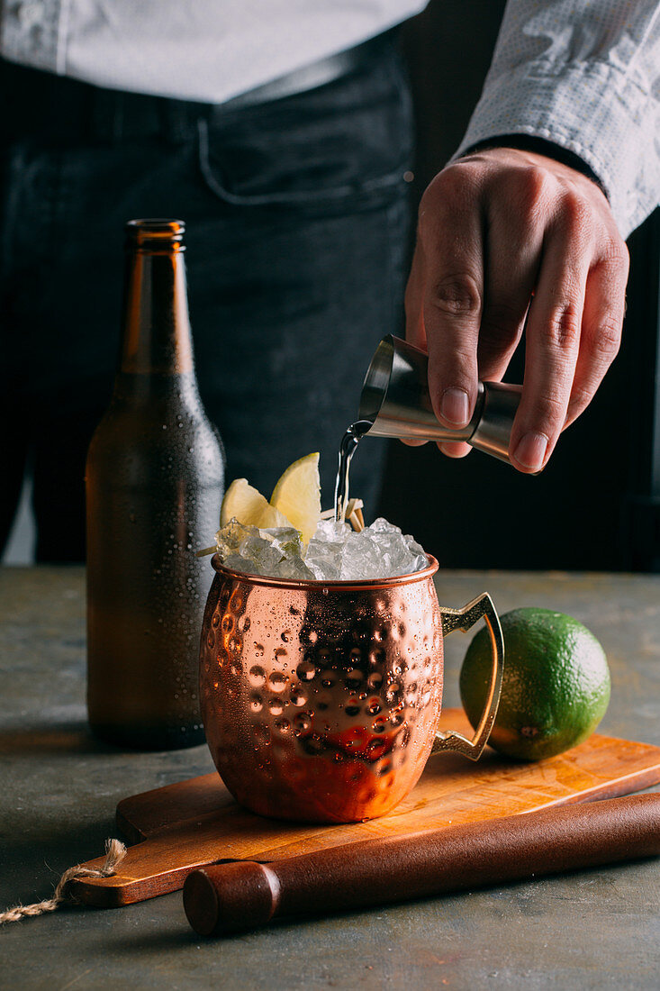 Moscow Mule (cocktail with vodka, ginger beer and lime) being made