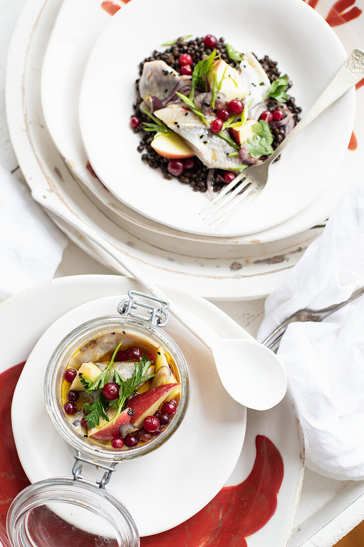 Herring on beluga lentils with apples and cranberries