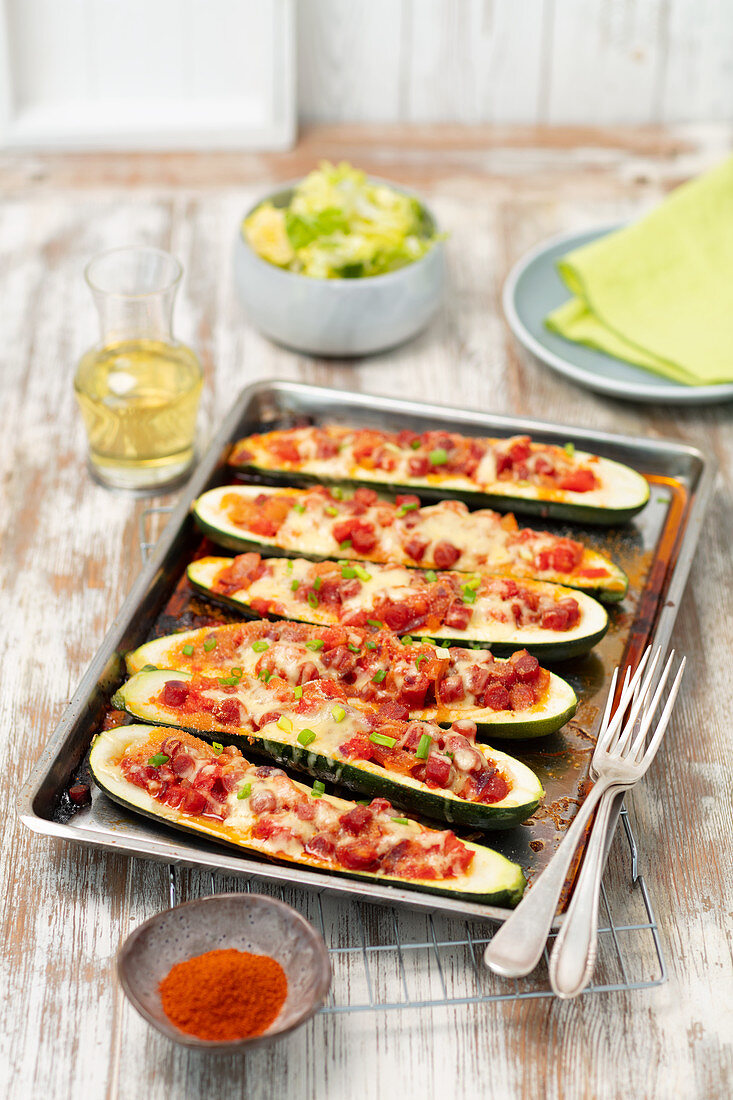 Baked courgette stuffed with sausage and tomatoes