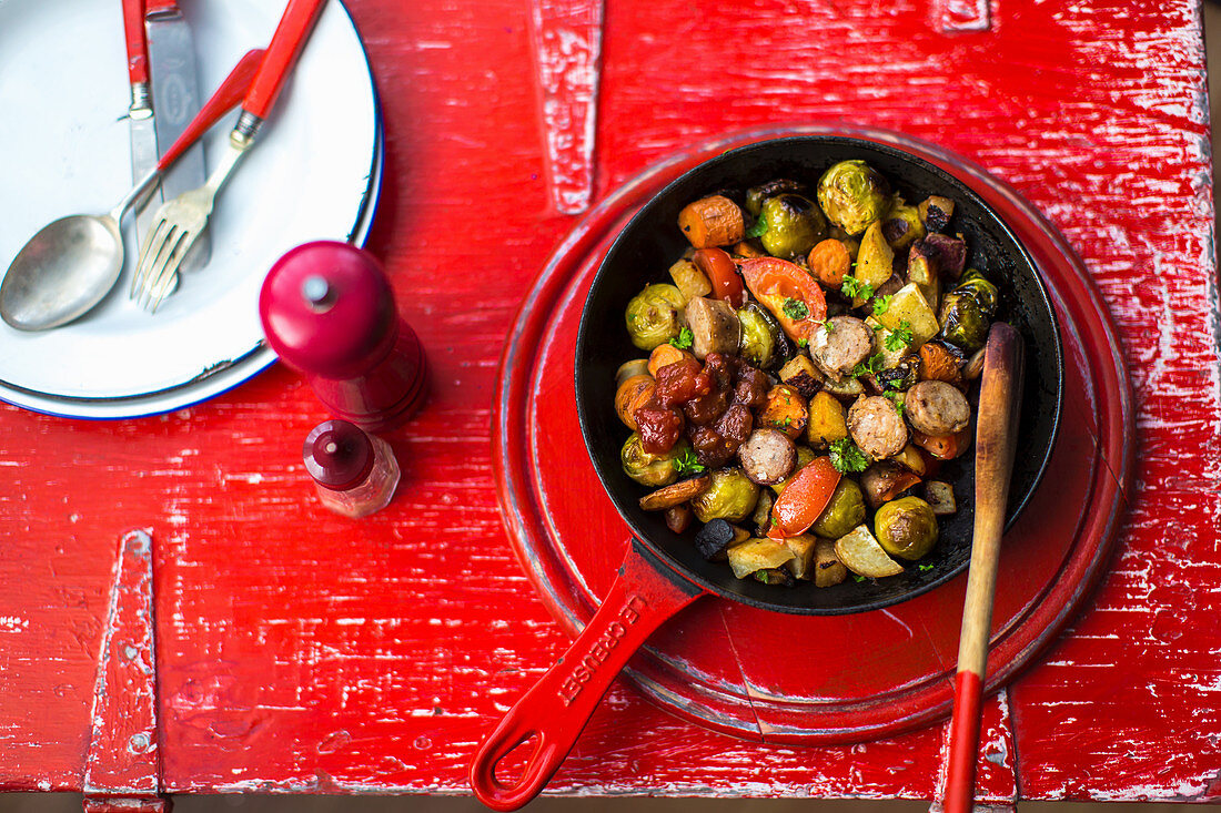 Sausages with brussels sprouts, sweet potatoes and tomatoes