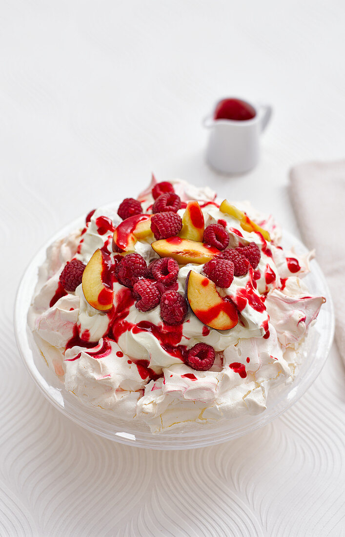 Pavlova with berries and plums