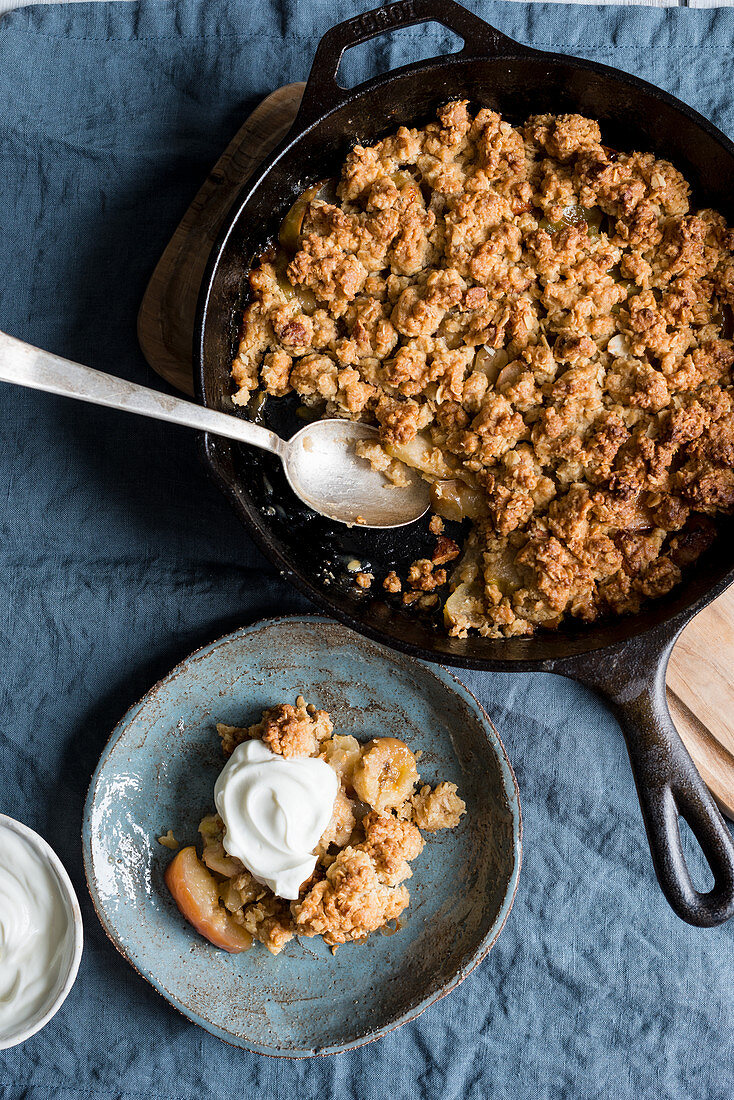 Apple and banana oat crumble with almonds served with greek yogurt