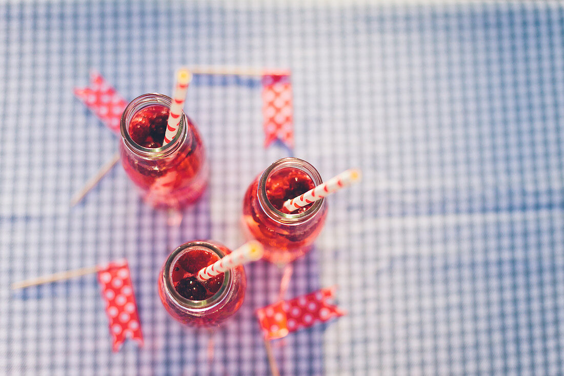 Bottles with fresh berry drink