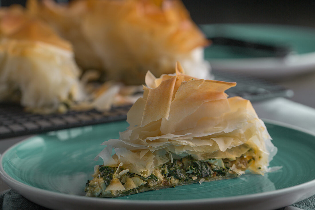 A piece of spanakopita (filo pastry with spinach and feta cheese, Greece)