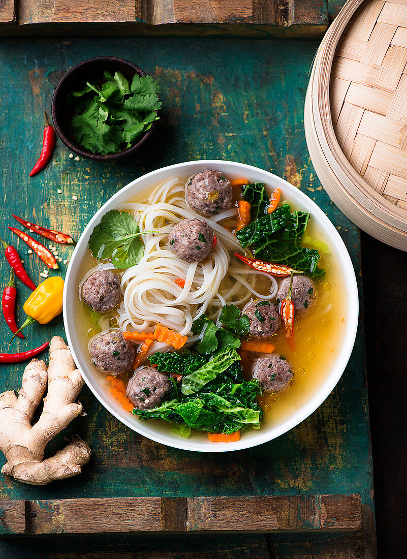 Rice noodle soup with meatballs and savoy cabbage (Asia)