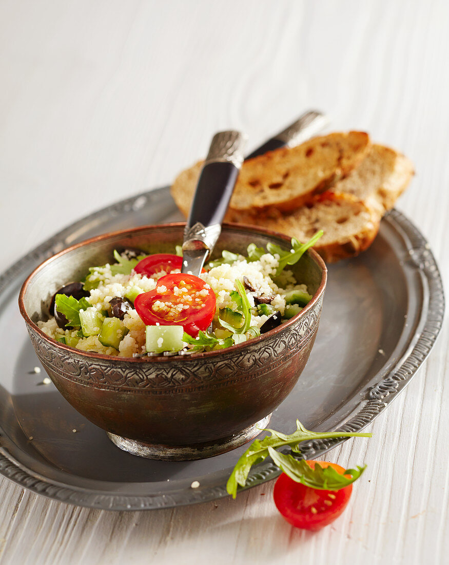 Couscous salad with rocket, olives and toasted bread