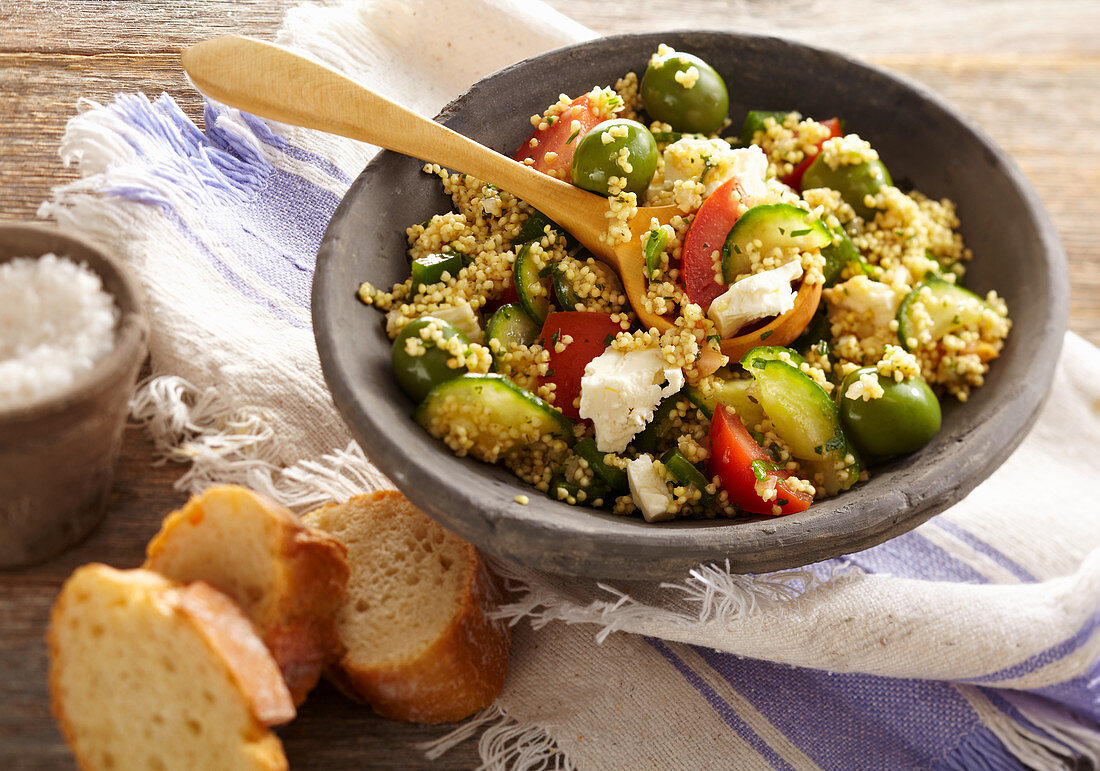 Greek millet salad with feta, cucumber, tomato and green olives