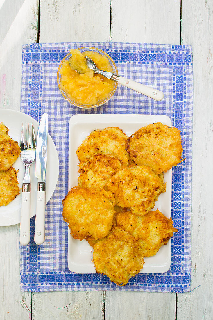Potato pancakes with applesauce on a blue and white cloth