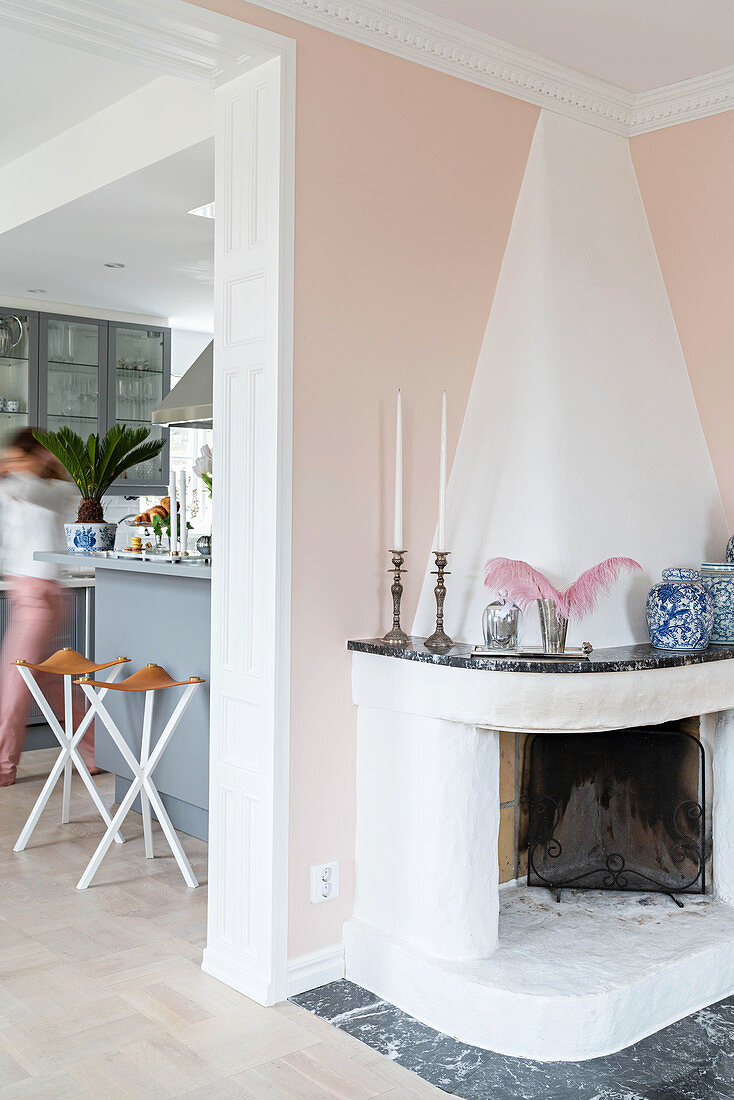 Masonry fireplace with marble surround in corner of living room