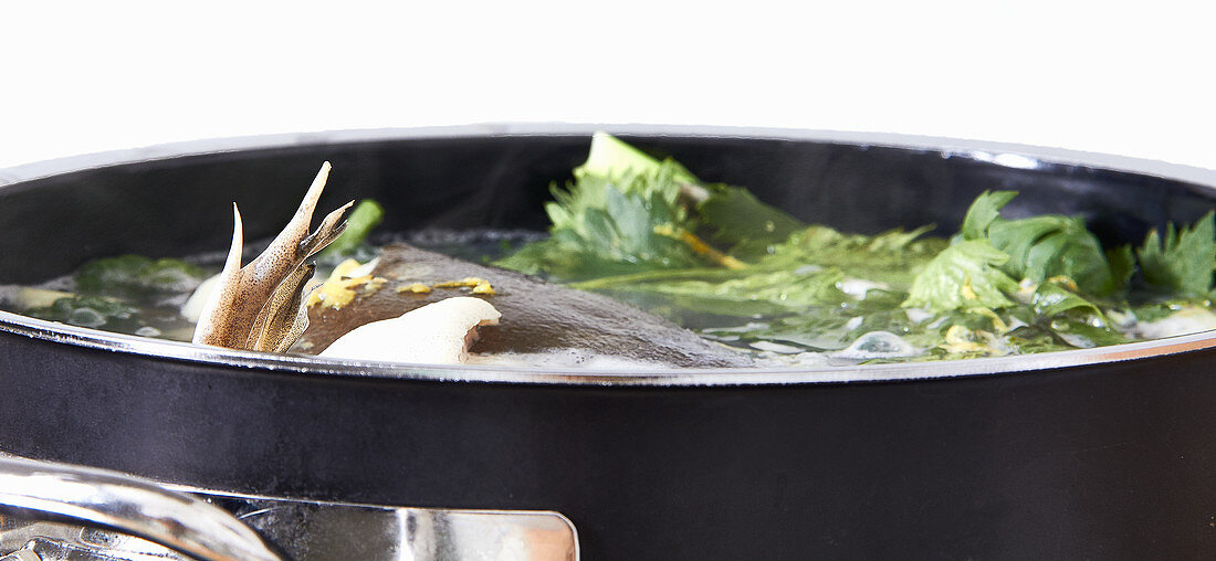 Fish stock in a saucepan