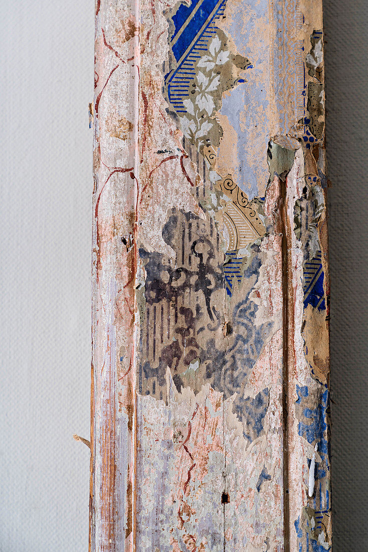 Detail of old wooden beam with traces of antique painted ornamentation