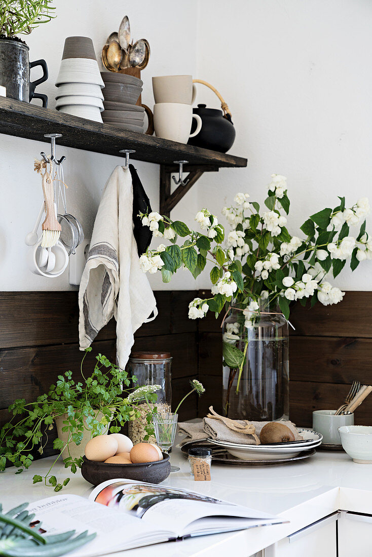 Bouquet of mock orange branches in rustic kitchen