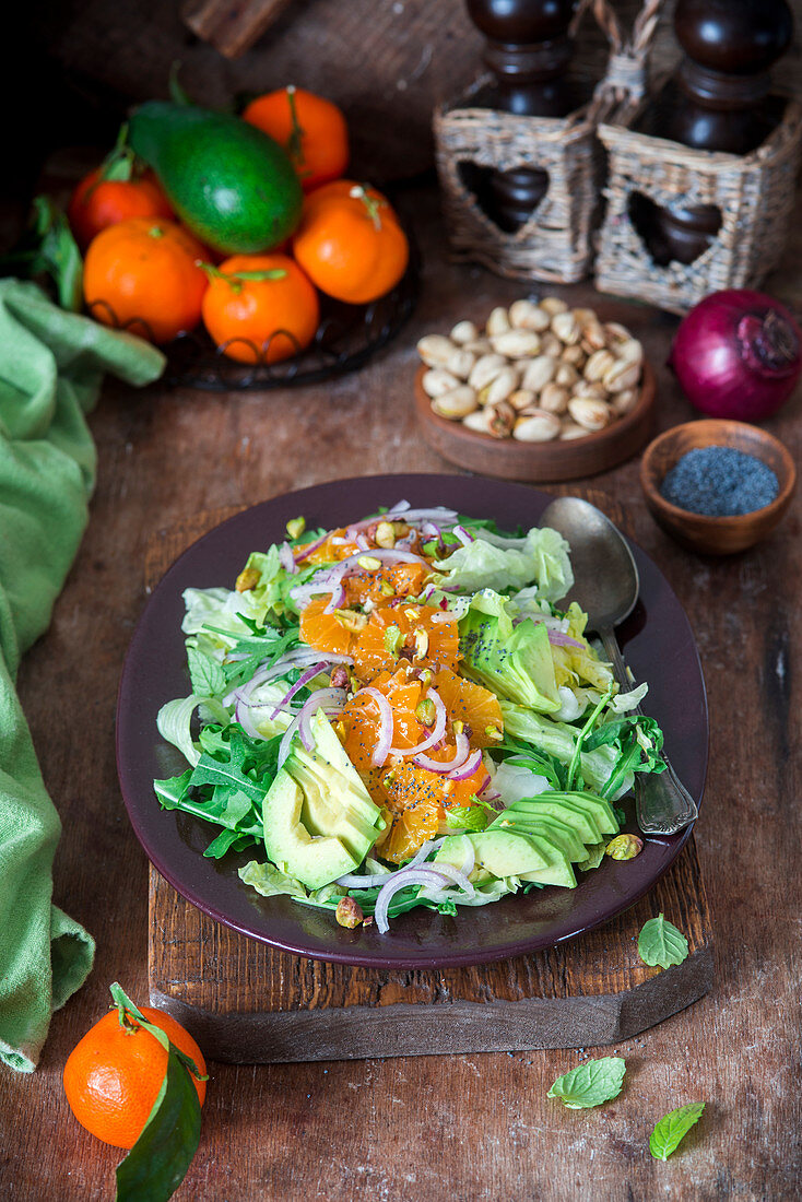Avocado salad with tangerines, pistachios and red onions