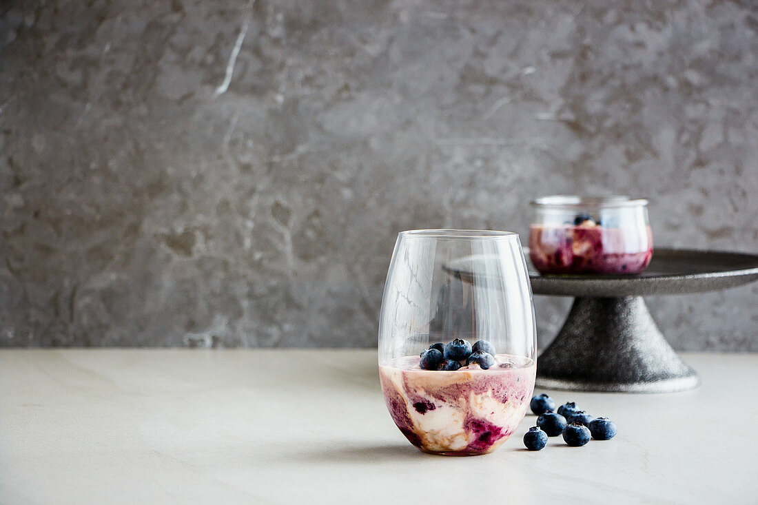 Delicious blueberry dessert in glass with fresh berries
