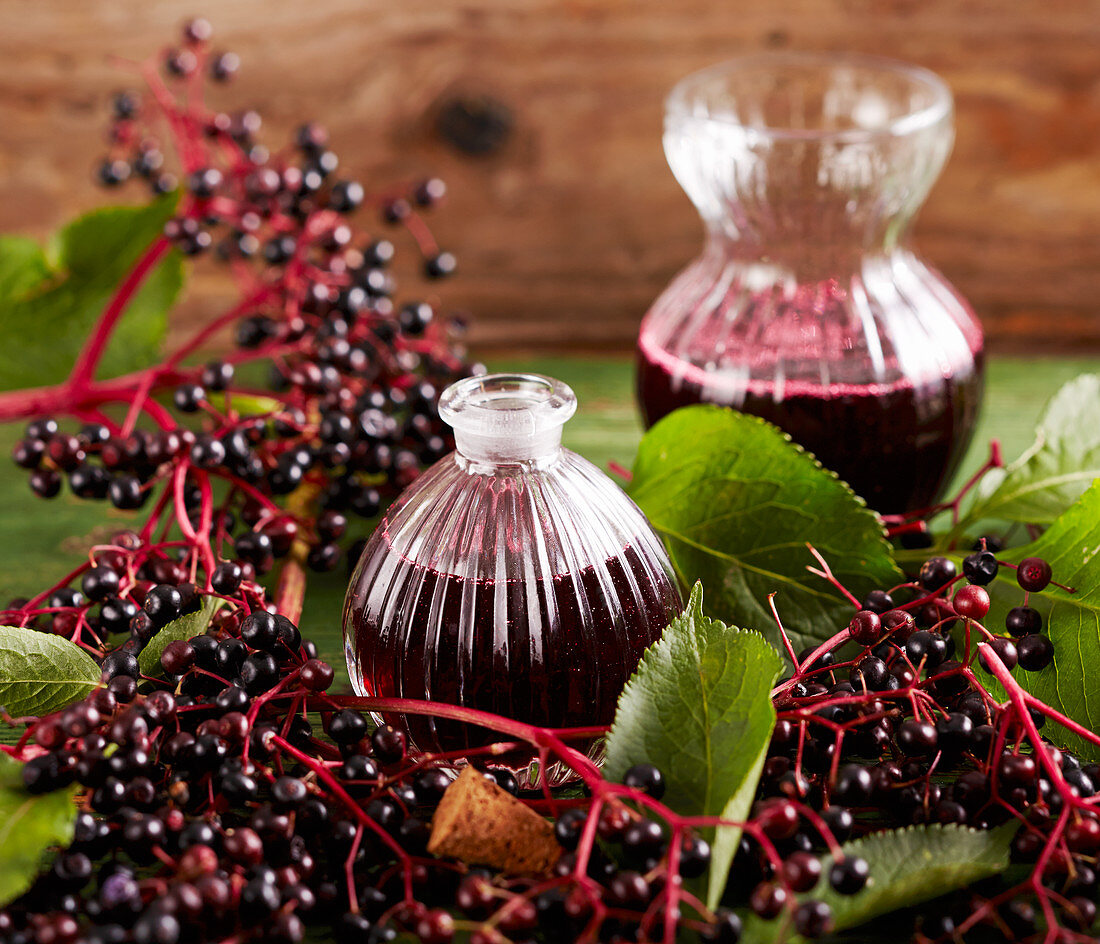 Homemade elderberry syrup in carafes