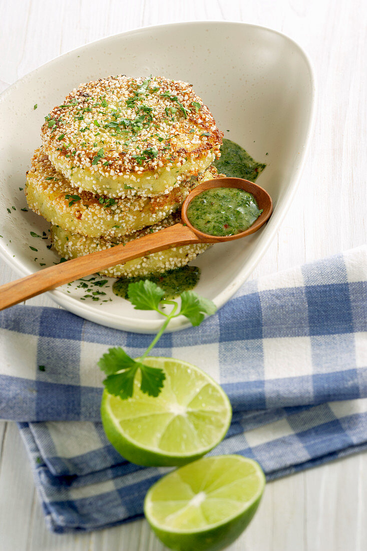 Fried potato cakes with amaranth pops and lime and herb sauce