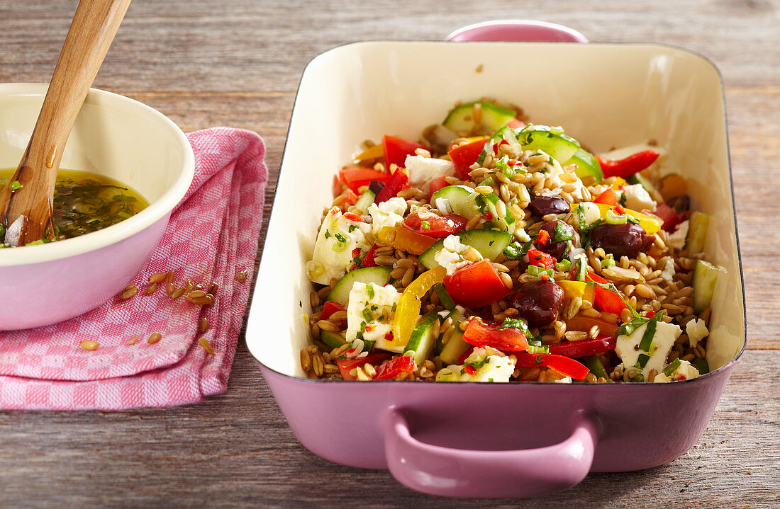 Spelt salad with feta, olives, peppers, cucumber and spicy dressing