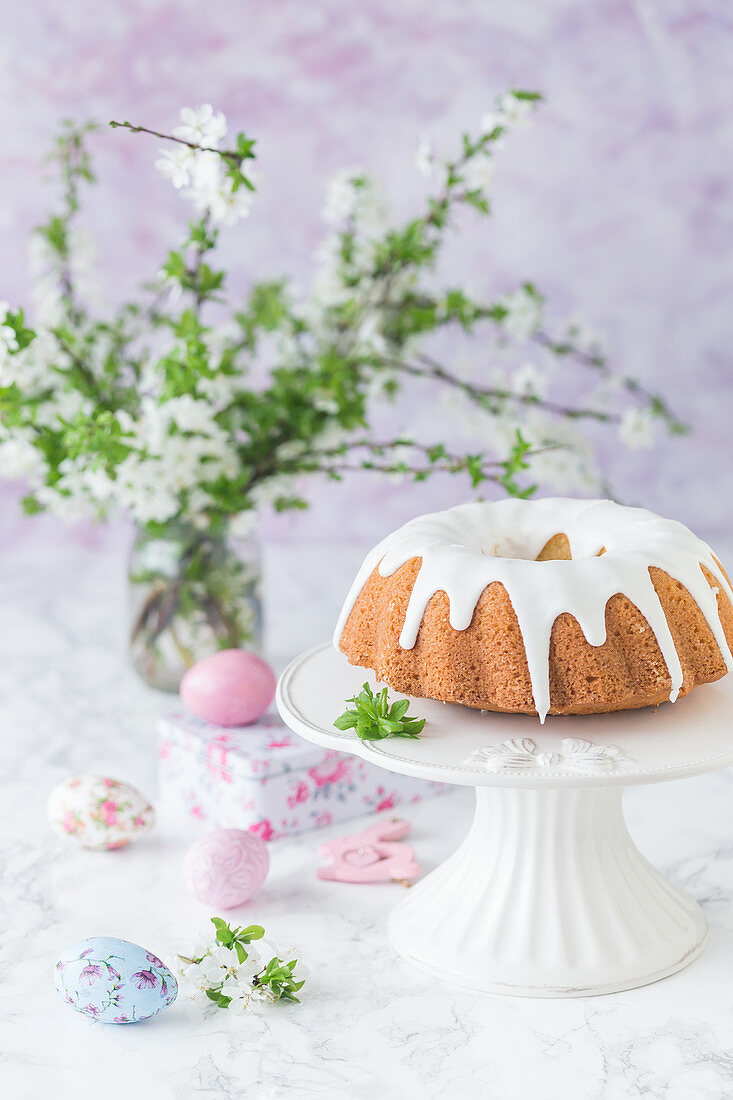 Easter bundt cake with royal icing, on a cake stand