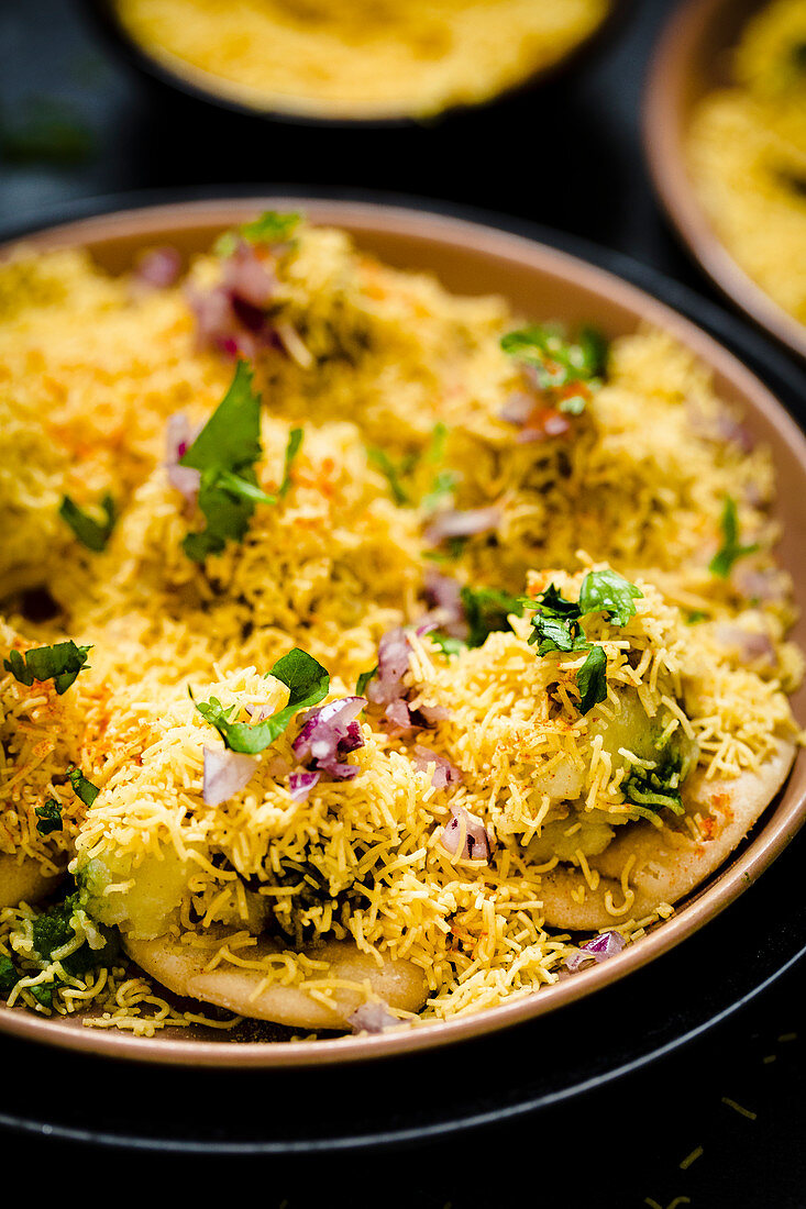 Sev puri (Indian snack made form potatoes, onions and chutney)
