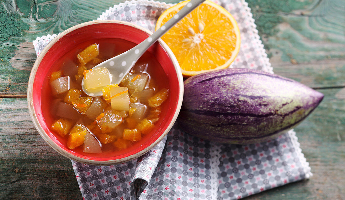 Pickled sweet and sour pepino melons with oranges, sugar and fruit vinegar