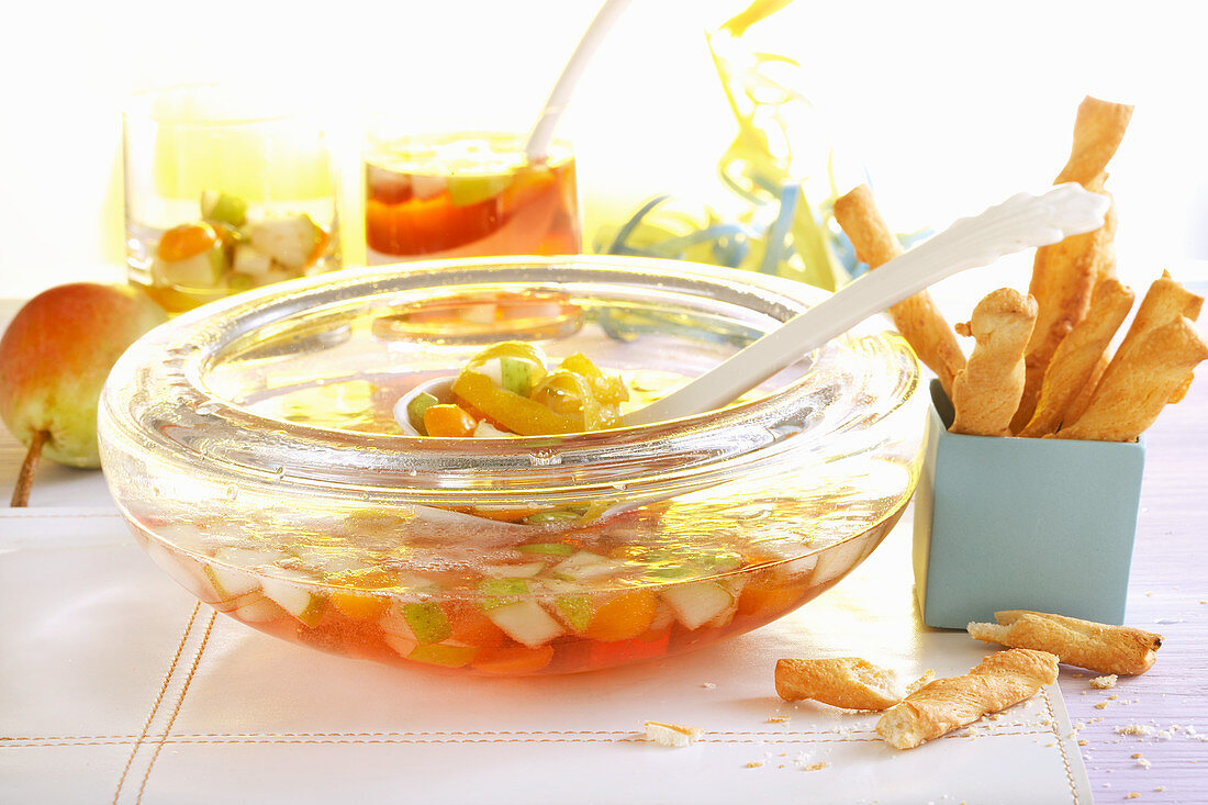 Pear punch with physalis served with savoury snacks