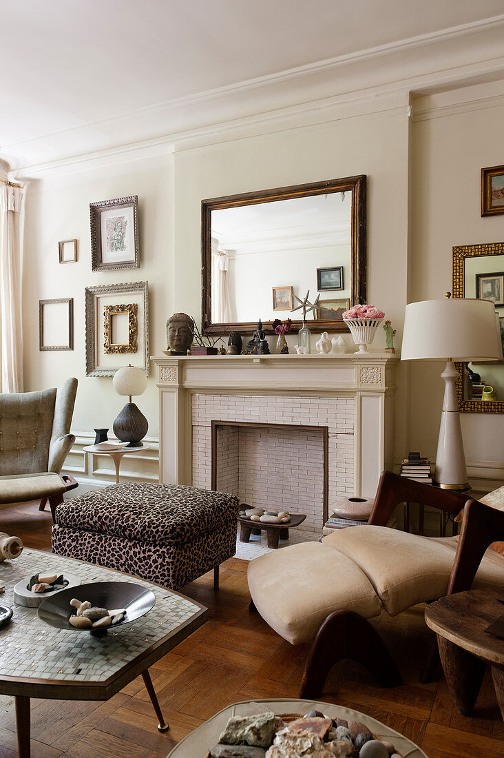 An classic lounge chair in corner of sitting room with leopard print ottoman and Italian mosaic table