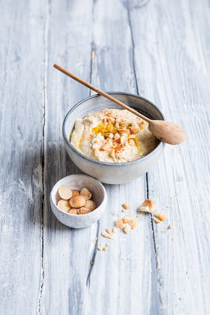 A bowl of hummus with a spoon