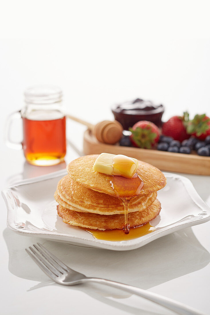 Classic Pancakes with butter and honey dripping