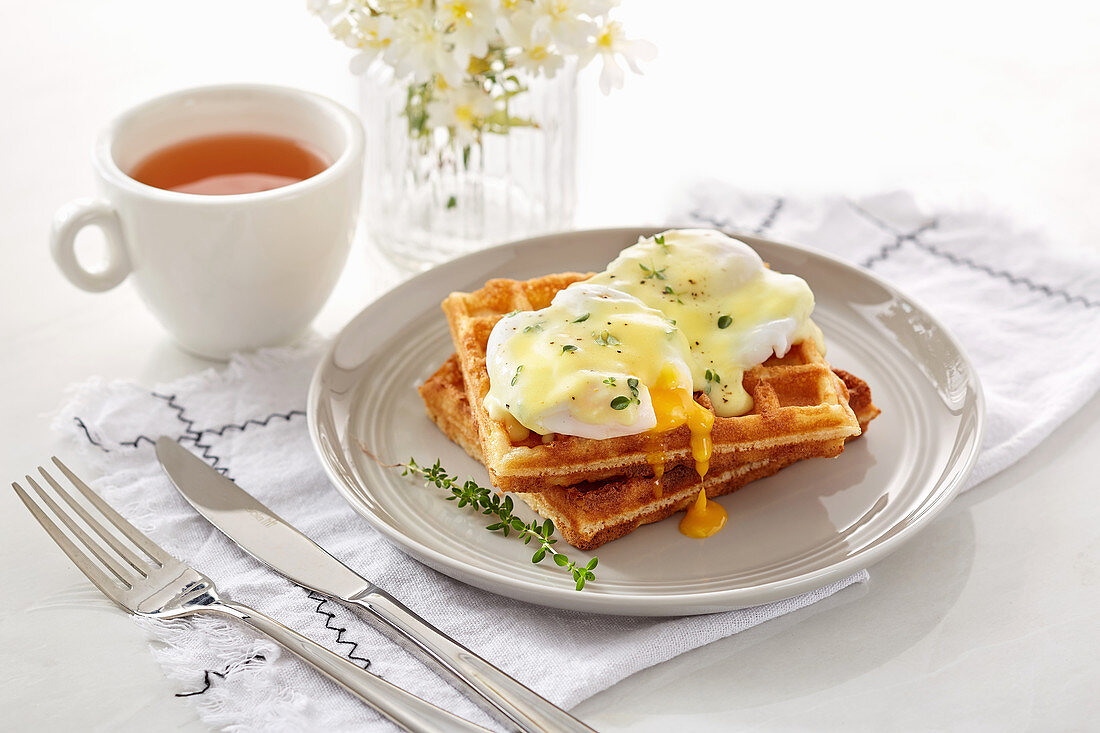 Waffle with opened poached eggs