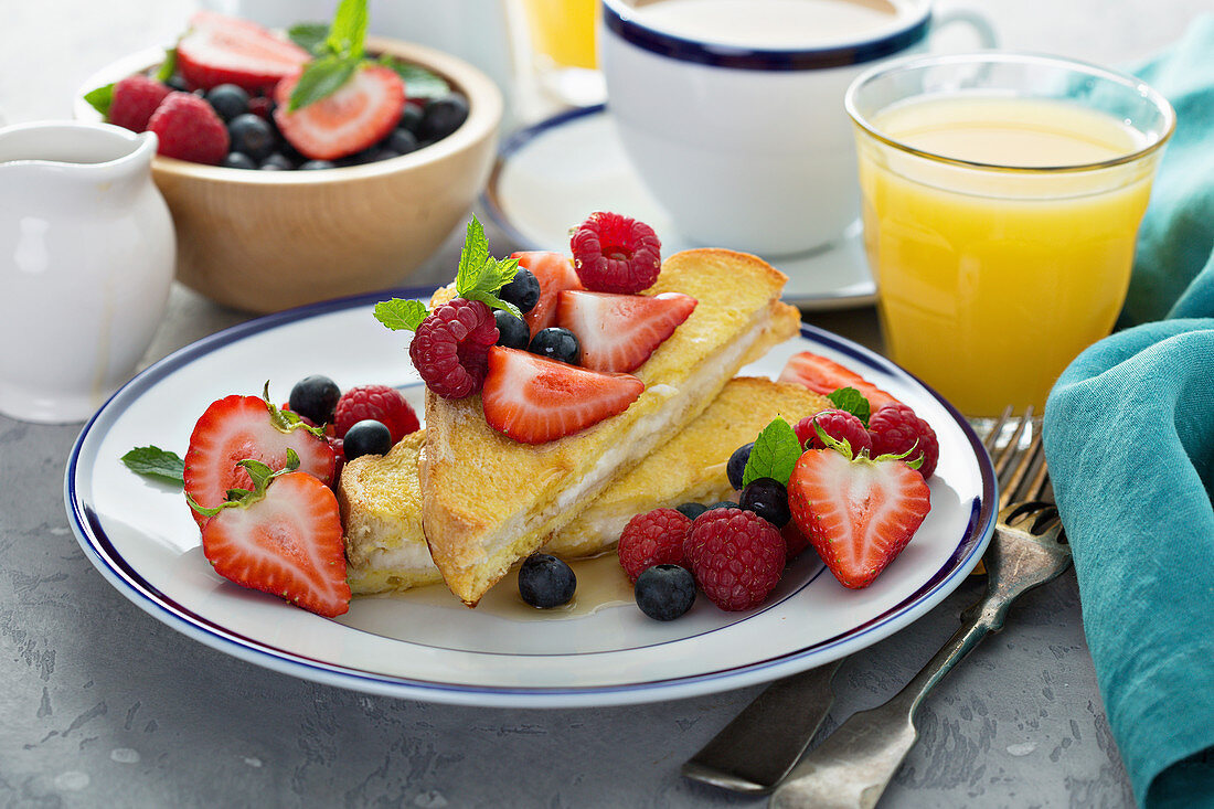 Baked french toast with cream cheese filling and fresh berries