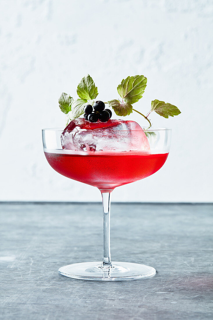 A cocktail with blueberries and ice cream
