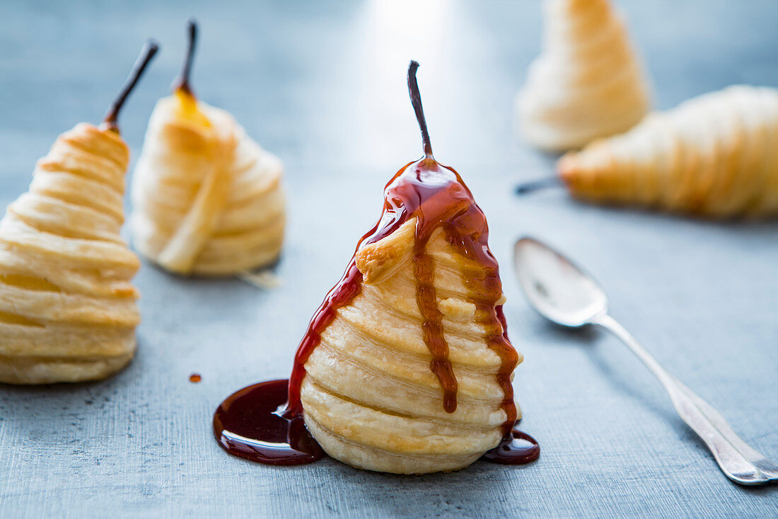 Poached pears wrapped in puff pastry