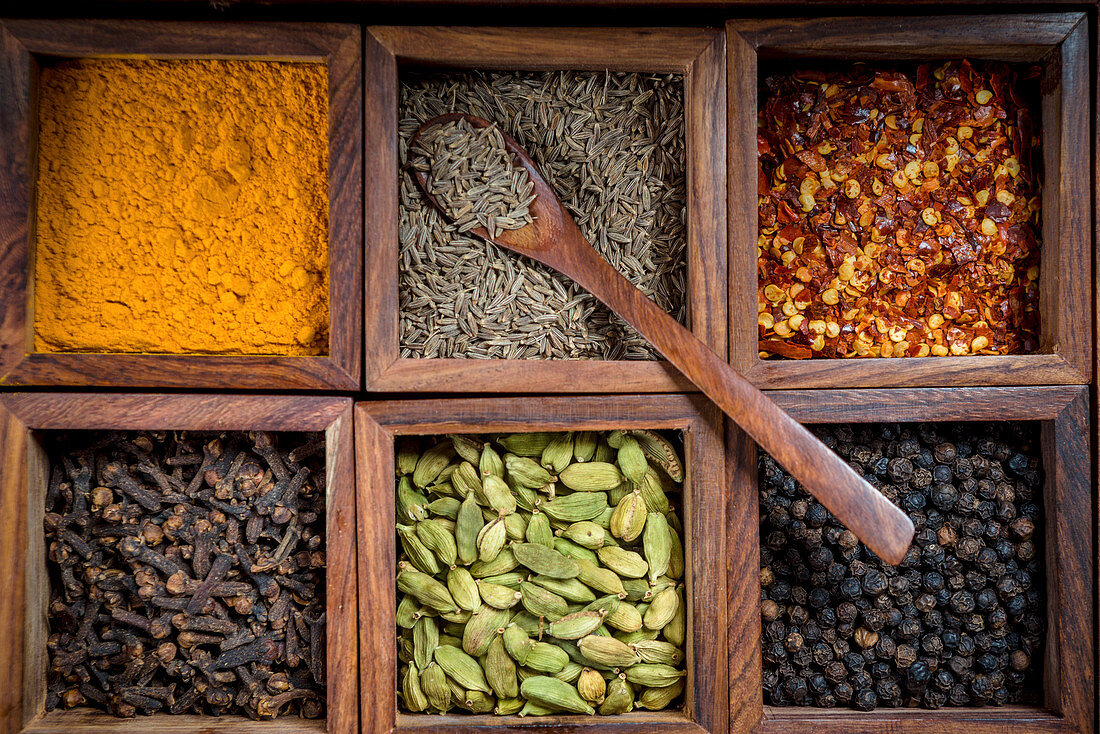 Various spices in a wooden boxes