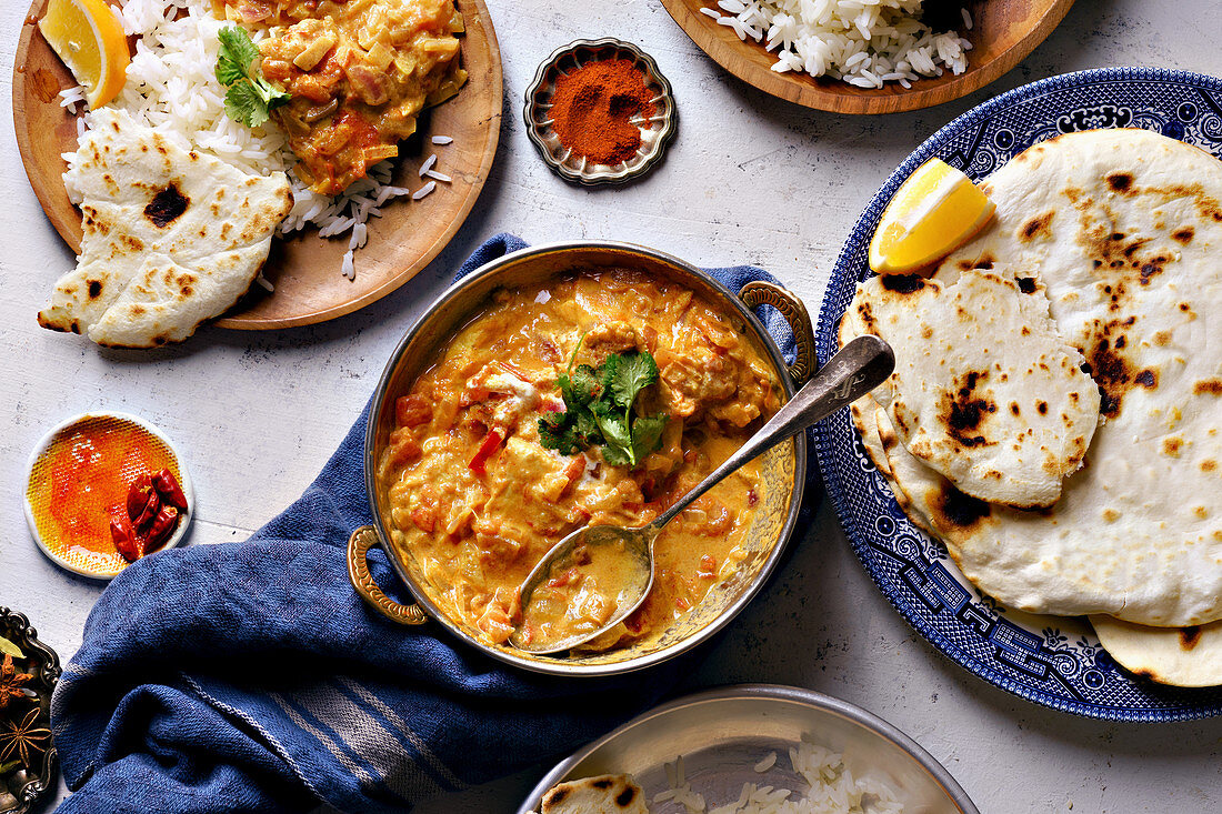 Indian chicken tikka masala with rice and naan bread