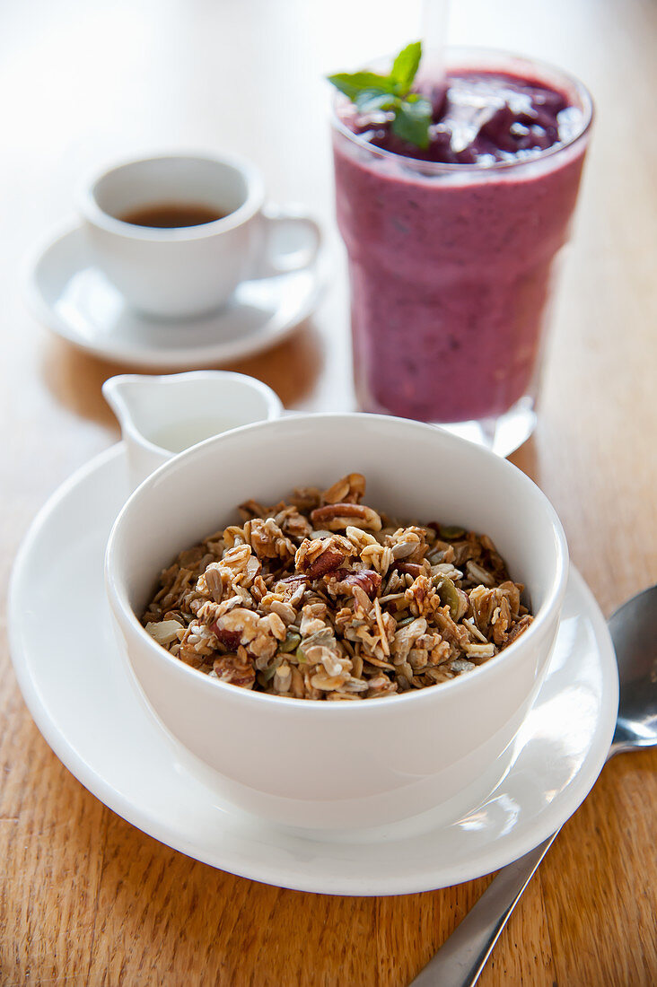 Breakfast muesli, a smoothie and coffee
