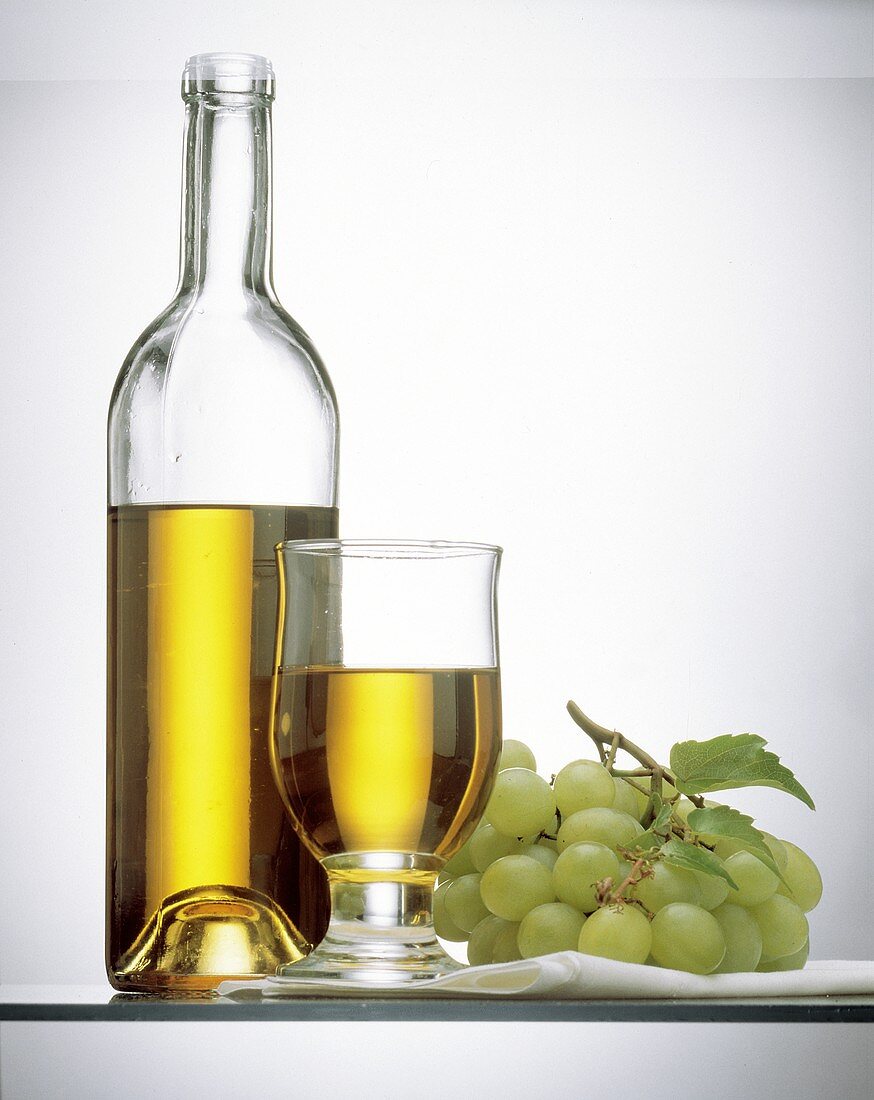 White Grape Juice in a Bottle and in a Glass; Grapes