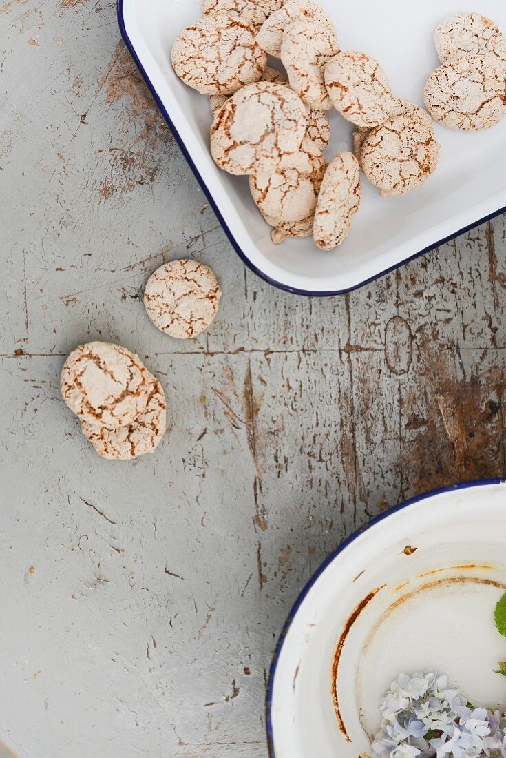 Biscuits in and next to dish on worn tabletop