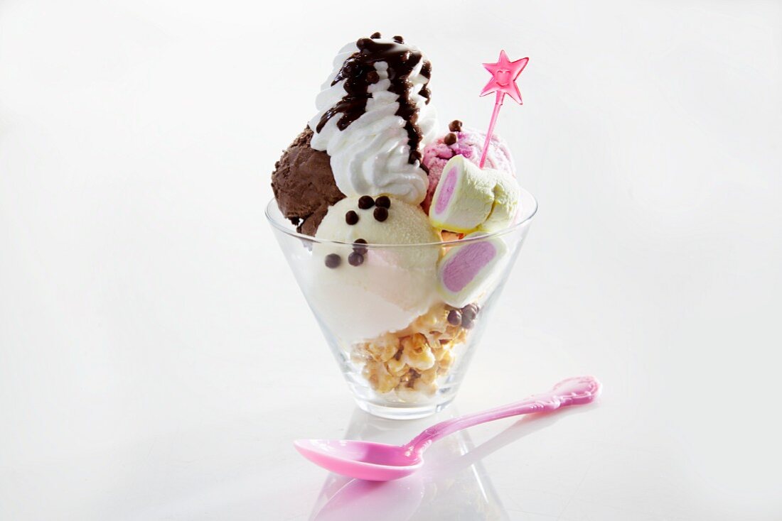 An ice cream sundae with sweets and cream