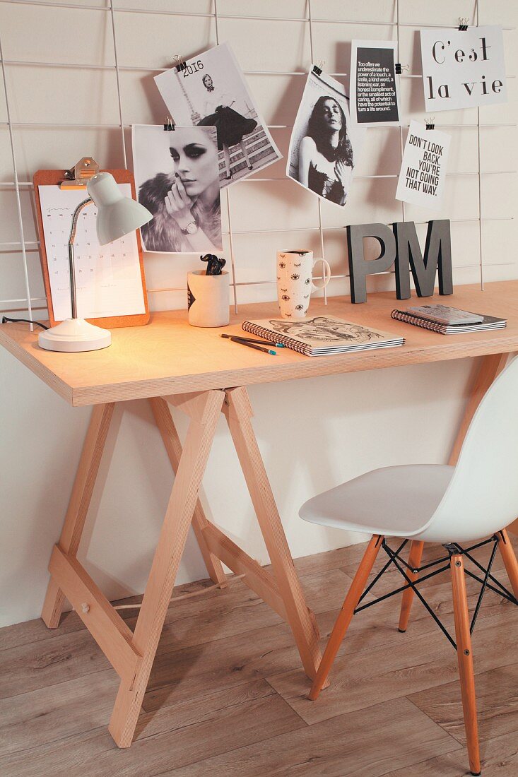 Desk on trestles and wire mesh pinboard