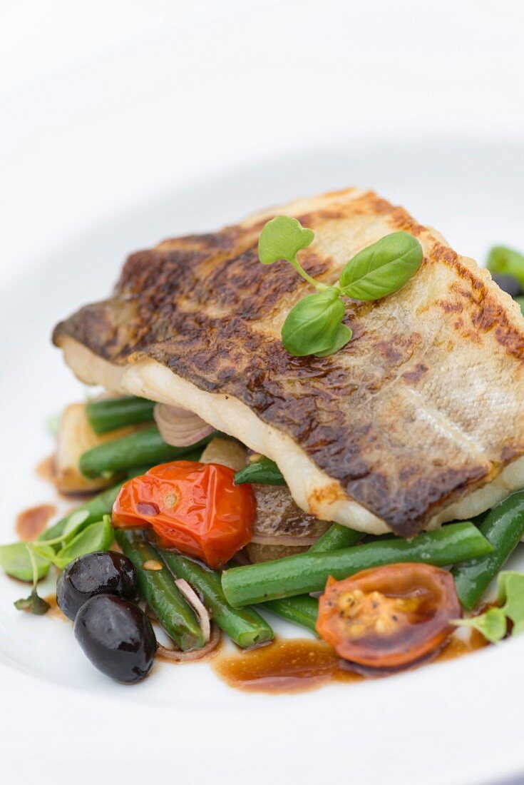 Pan fried fish on a bed of vegetables